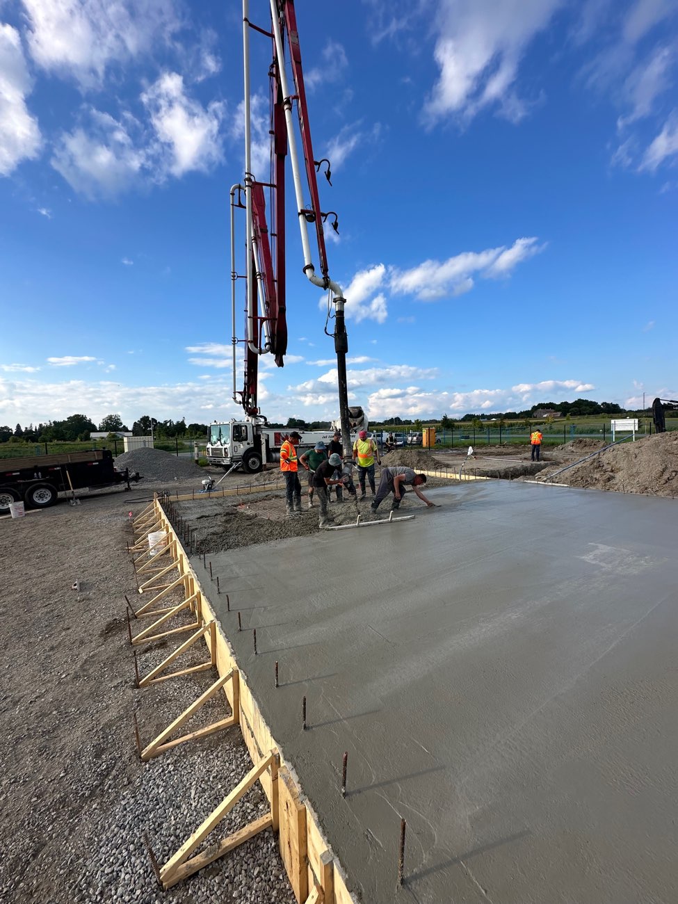 Teston crew placing and screeding a concrete slab in the GTA